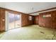 Living room with wood paneling, slider to backyard at 643 Alf Hoover Rd, Lincolnton, NC 28092