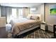 A relaxing bedroom with a queen-sized bed, painted brick wall, and natural light streaming through the doorway at 670 Allenton St, Norwood, NC 28128