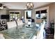 Bright dining room features a large glass-top table and chairs, a globe chandelier, and lake views from three windows at 670 Allenton St, Norwood, NC 28128