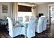 Bright dining room features a large glass-top table and chairs, wooden floors, and natural light from a window at 670 Allenton St, Norwood, NC 28128