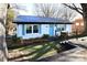 Charming renovated home featuring a blue door and shutters, fresh paint, and landscaping at 670 Allenton St, Norwood, NC 28128