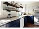 Kitchen area with two-tone cabinets, stainless steel appliances, and decorative open shelving at 670 Allenton St, Norwood, NC 28128