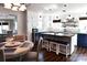 Kitchen with two-tone cabinetry, center island with seating, decorative shelving and eat-in breakfast nook at 670 Allenton St, Norwood, NC 28128