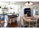 Bright kitchen with two-tone cabinets, island seating, and adjacent breakfast nook offers ample space at 670 Allenton St, Norwood, NC 28128