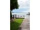 Private pier on the lake featuring a seating area with chairs, a table, and grassy area at 670 Allenton St, Norwood, NC 28128