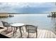 Charming waterfront view featuring a table and chairs on the deck overlooking the serene lake at 670 Allenton St, Norwood, NC 28128