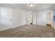 Well-lit bedroom with neutral carpeting and two closets at 7015 Cardigan Ave, Charlotte, NC 28215