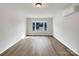 Living room with hardwood floors and a large bay window at 7015 Cardigan Ave, Charlotte, NC 28215