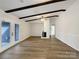 Living room with hardwood floors, exposed beams, and fireplace at 7015 Cardigan Ave, Charlotte, NC 28215