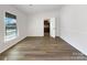 Spacious living room featuring hardwood floors and a view into the kitchen at 7015 Cardigan Ave, Charlotte, NC 28215