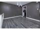 Dining area with grey walls and laminate wood flooring at 7912 Charter Oak Ln, Charlotte, NC 28226