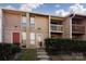 Two-story condo building exterior with landscaping and steps leading to the entrance at 7912 Charter Oak Ln, Charlotte, NC 28226