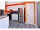 Kitchen with orange walls, white cabinets, and stainless steel appliances at 7912 Charter Oak Ln, Charlotte, NC 28226