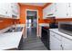 Kitchen with orange walls, white cabinets and stainless steel appliances at 7912 Charter Oak Ln, Charlotte, NC 28226