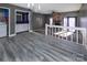 Living room with grey walls, stone fireplace, and grey laminate floors at 7912 Charter Oak Ln, Charlotte, NC 28226