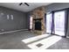 Living room with stone fireplace and sliding glass doors leading to a patio at 7912 Charter Oak Ln, Charlotte, NC 28226