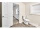 Simple half bathroom with toilet and view into kitchen at 815 3Rd St, Kings Mountain, NC 28086