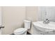 Small bathroom with white sink, toilet, and tiled backsplash at 815 3Rd St, Kings Mountain, NC 28086