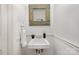 Stylish powder room featuring a unique mirror, small sink, and neutral decor at 821 Greentree Dr, Charlotte, NC 28211