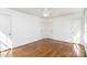 Neutral bedroom with three doors, hardwood floors, ceiling fan, and a simple design at 821 Greentree Dr, Charlotte, NC 28211