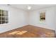 Bright, airy bedroom with hardwood floors, large windows, and simple design at 821 Greentree Dr, Charlotte, NC 28211