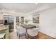 Well-lit dining area featuring hardwood floors, comfortable seating for six, and a view of the backyard through french doors at 821 Greentree Dr, Charlotte, NC 28211