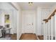 Bright entryway with hardwood floors, a white front door, and a staircase leading to the upper level at 821 Greentree Dr, Charlotte, NC 28211