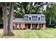 Charming brick home featuring a well-manicured front lawn and classic architectural details at 821 Greentree Dr, Charlotte, NC 28211