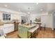 Bright kitchen featuring stainless steel appliances, an island with a granite countertop, and a clear view to a dining area at 821 Greentree Dr, Charlotte, NC 28211