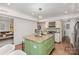 Bright kitchen featuring stainless steel appliances, an island with a granite countertop, and a clear view into the living area at 821 Greentree Dr, Charlotte, NC 28211