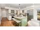 Bright kitchen featuring stainless steel appliances, an island with a granite countertop, and hardwood floors at 821 Greentree Dr, Charlotte, NC 28211