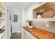 Bright laundry room with wooden countertops, white cabinets, and modern appliances at 821 Greentree Dr, Charlotte, NC 28211