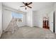 Spacious bedroom with neutral carpet, ceiling fan, and large window at 8312 Compton Acres Ln, Waxhaw, NC 28173