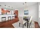 Open-concept dining area with modern light fixture, seating for four, and a view of the kitchen at 8312 Compton Acres Ln, Waxhaw, NC 28173