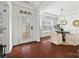 Bright dining room featuring hardwood floors, modern light fixture, front door, and large window at 8312 Compton Acres Ln, Waxhaw, NC 28173