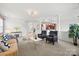 Open-concept living room featuring a fireplace, sofa, two chairs, view to staircase and kitchen at 8312 Compton Acres Ln, Waxhaw, NC 28173