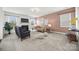 Spacious living room featuring a fireplace, sofa, two chairs and a neutral color palette at 8312 Compton Acres Ln, Waxhaw, NC 28173