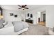 Bright main bedroom with neutral carpet, ceiling fan, and a doorway leading to the ensuite bathroom at 8312 Compton Acres Ln, Waxhaw, NC 28173