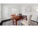 Office space with a desk, chair, patterned rug and French doors with view to the dining room at 8312 Compton Acres Ln, Waxhaw, NC 28173