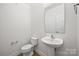 Clean powder room featuring a pedestal sink and tile flooring at 8312 Compton Acres Ln, Waxhaw, NC 28173