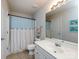 Cozy bathroom features a vanity with mirror, toilet, and shower with modern fixtures and charming decor at 9613 Long Hill Dr, Charlotte, NC 28214