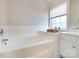 Bathroom features a large soaking tub and a window at 9613 Long Hill Dr, Charlotte, NC 28214