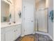 Bathroom features a glass door shower, vanity, and neutral walls at 9613 Long Hill Dr, Charlotte, NC 28214