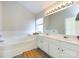 Bathroom features double sinks, a soaking tub, and neutral walls at 9613 Long Hill Dr, Charlotte, NC 28214