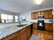 Bright kitchen with a large island, wooden cabinets, granite countertops, and modern appliances at 9613 Long Hill Dr, Charlotte, NC 28214