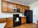 Charming kitchen featuring wood cabinetry, stainless microwave and modern black appliances at 9613 Long Hill Dr, Charlotte, NC 28214