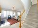 Bright living room with staircase, fireplace, and comfortable seating at 9613 Long Hill Dr, Charlotte, NC 28214