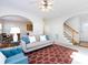 View of a living room with fireplace and staircase, creating a warm atmosphere at 9613 Long Hill Dr, Charlotte, NC 28214