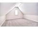 Bright, carpeted attic space with a small window and neutral paint, perfect for storage or a bonus room at 102 W Vista View Pl, Mooresville, NC 28117