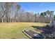 Expansive backyard lawn with mature trees, offering plenty of room for outdoor activities and gardening at 102 W Vista View Pl, Mooresville, NC 28117